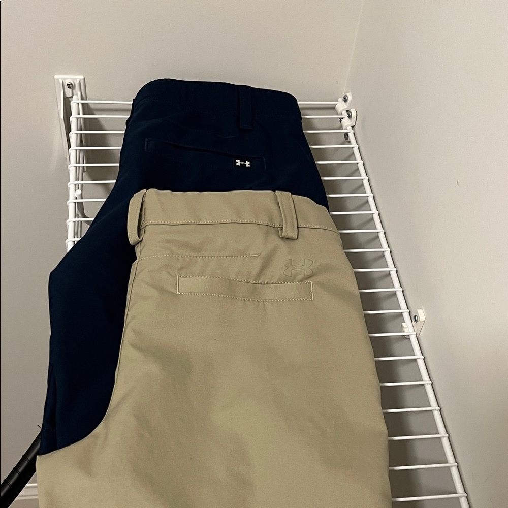 2 Under Armour golf shorts one Navy Blue and one khaki.